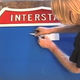 Image for article titled How One Fed-Up Dude Fixed an Awful Highway Sign Himself